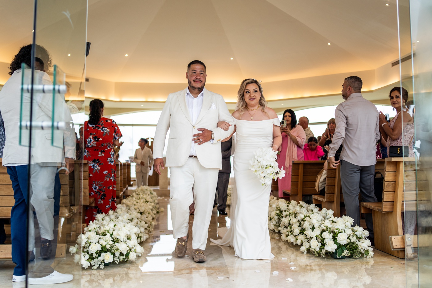 Bride and groom exiting their wedding ceremony at Moon Palace Cancùn