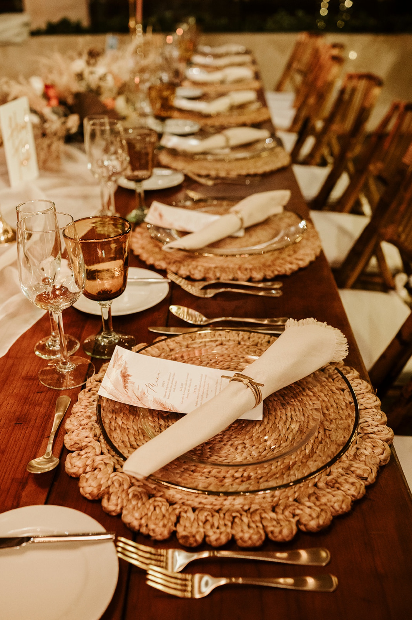 Round jute placemat and fringed linen napkins on a boho wedding table