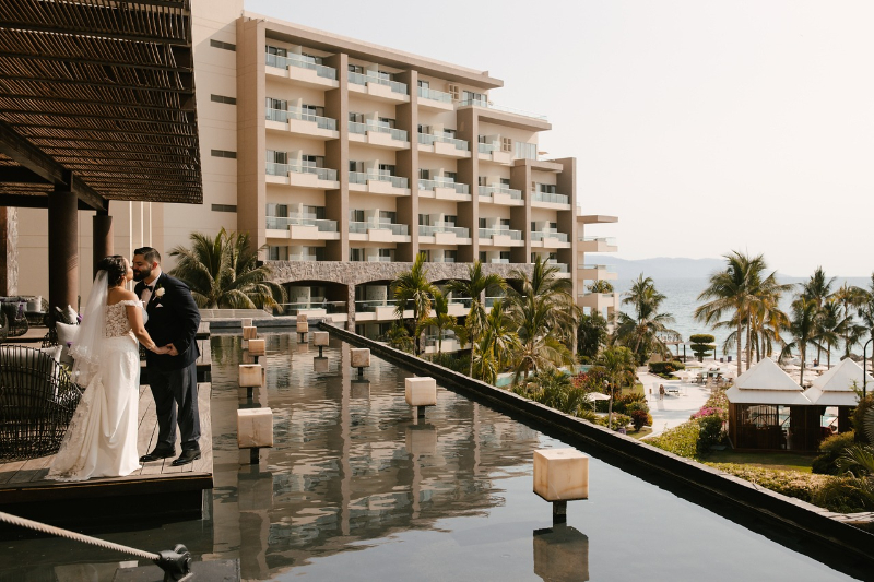 Just engaged couple at luxury beach resort, romantic destination wedding moment with ocean view and tropical setting